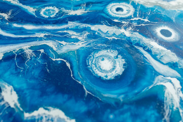 Epoxy resin art background. Resin art with blue and white colors. Abstract composition.