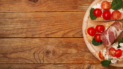 Italian appetizer. Bruschetta on a wooden board on a wooden rustic background
