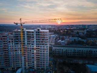 aerial view of apartment construction site with crane