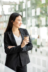 Portrait of Accounting businesswoman working on note laptop computer and analyzing real estate investment data, Financial and tax systems concept.