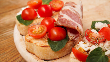 Italian appetizer. Bruschetta on a wooden board on a wooden rustic background