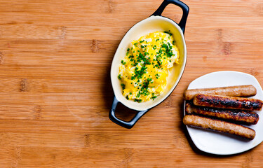 Eggs and bacon. Breakfast or brunch buffet. Sausage, bacon, Bagels, muffins, croissants, cinnamon rolls, sunny side up eggs, bacon, butter, jelly, & cream cheese. Classic American or French breakfast.