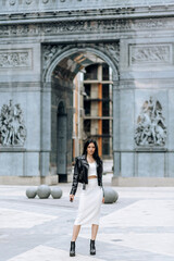 Young beautiful brunette fashionable outfit walking in the city