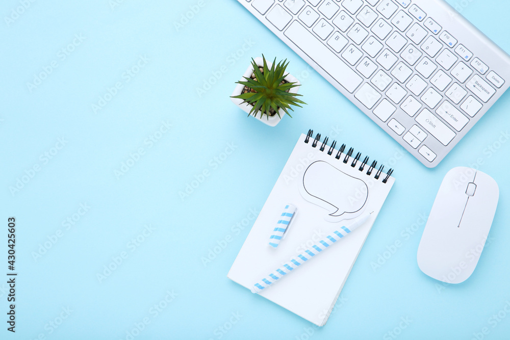 Poster computer keyboard with mouse, green plant and notepad on blue background