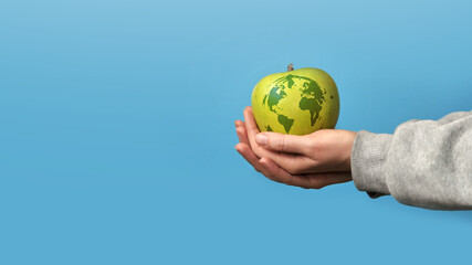 Drawing of the planet Earth on an apple. A symbol of love and care for the environment and the earth
