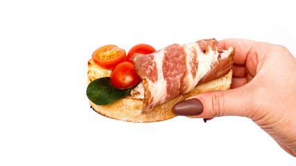 Bruschetta on ciabatta in hand on a white background. Italian appetizer isolated