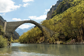 Fototapeta na wymiar Pedestrian stone bridge Konitsa over river Aoos or Vjose in northwestern Greece, Europe.