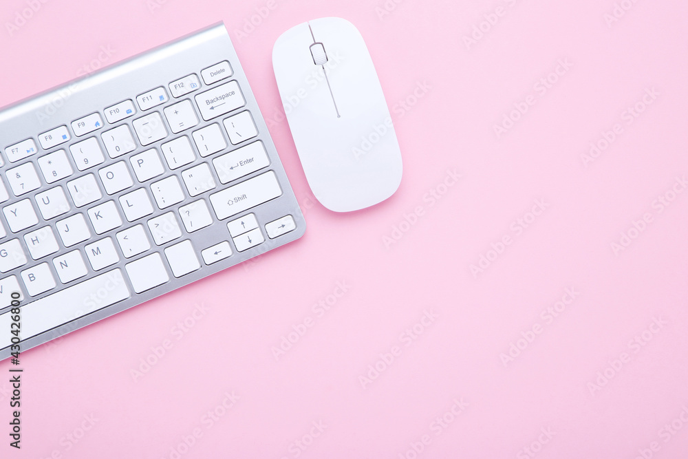 Poster computer keyboard and mouse on pink background