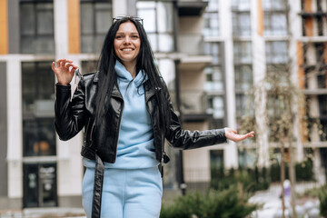 Young brunette girl happily demonstrates the keys to her new home