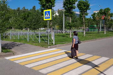 A man at a crosswalk. Traffic safety in the city.