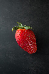 Delicious juicy ripe red strawberries on a pink background. Close-up shot of strawberries on a grater. Macro shot of garden strawberry