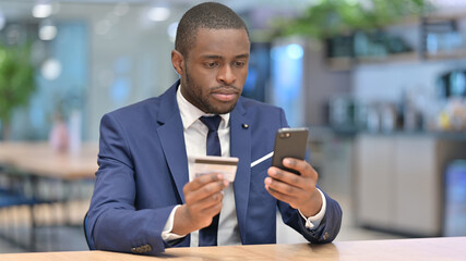 Online Payment Success on Smartphone for African Businessman 