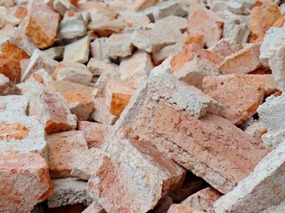 A broken orange brick with cement