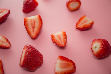 Delicious juicy ripe red strawberries on a pink background. Close-up shot of strawberries on a grater. Berry pattern