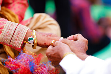 Maharashtra wedding ceremony in Hinduism : groom putting gold ring in finger