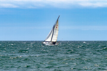 Fototapeta premium Sailboat on the Ontario lake in a windy day (Ontario, Canada).