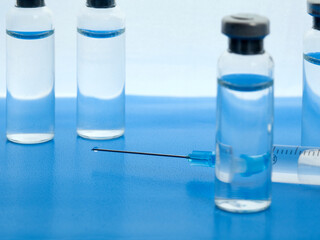 Close-up medical syringe and vials with medicine for injection