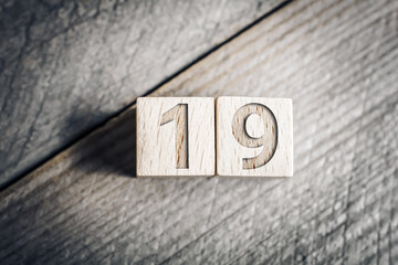 Number 19 Formed By Wooden Blocks On A Board