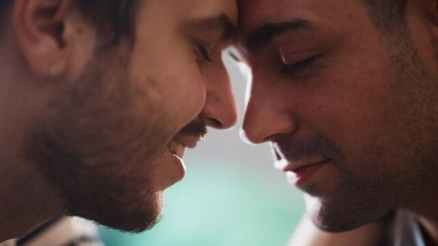 Authentic Close Up Footage of a Stylish Handsome Young Adult Gay Couple Spend Time at Home. Two Happy Men in Love in Casual Clothes Make a Gentle Headbutt. Cute LGBT Relationship Content.