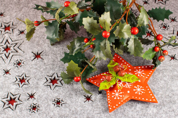 Christmas composition with holly branch and red star