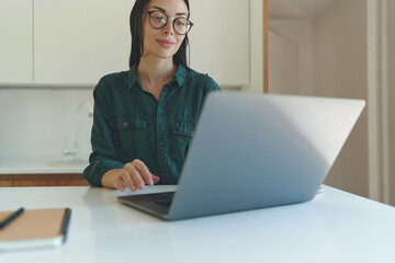 Cropped portrait of business woman working from home with laptop and smartphone