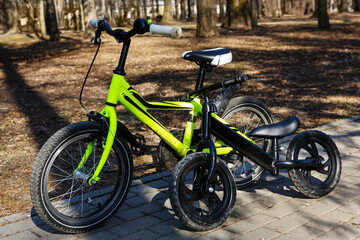 Fototapeta na wymiar Modern bicycles in a spring park. Healthy active lifestyle. Kid`s bicycle