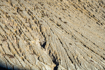 Mountain furrows wave surface pattern from lava flow at the top of Ijen volcano crater.Beautiful Landscape mountain and green lake with smoke sulfur in a Kawah Ijen volcano.East Java, Indonesia