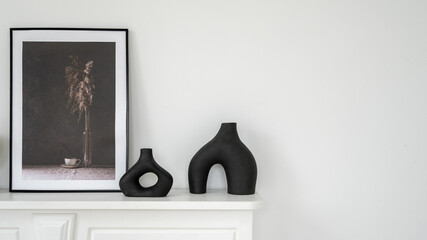 Vase and picture frame on shelf above fireplace
