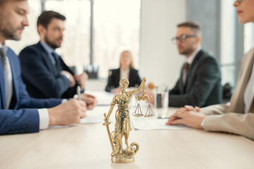 Themis with scales of justice on lawyers table