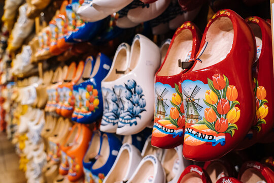 ZAANSE SCHANS, NETHERLANDS. November 2020. Dutch traditional colorful handmade wooden shoes, clogs with colorful paintings, symbol of Netherlands in souvenir shop in dutch village.