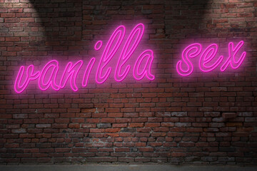 Obraz premium Neon vanilla sex lettering on Brick Wall at night