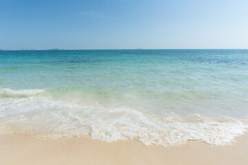 Fototapeta na wymiar Beach and waves tropical sea with blue sky on sunny day background. copy space..
