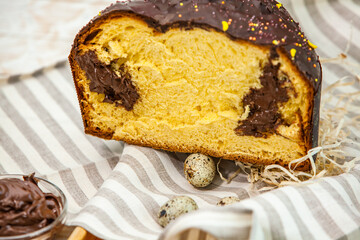 Panettone is the traditional Italian dessert for easter in 2021. Homemade panettone covered in chocolate and sprinkles. Bread served as dessert.