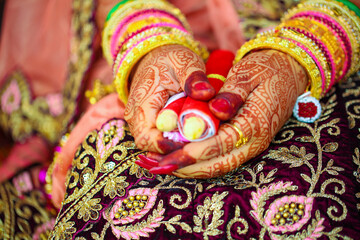 Hands of bride is decorated beautifully by indian mehndi art along with jewelery’s and colorful bangles