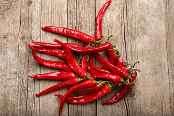 Hot peppers on a structural wooden background top view