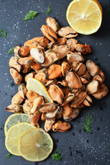 Mussels on a dark background with lemon top view