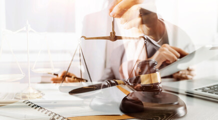 Business and lawyers discussing contract papers with brass scale on desk in office. Law, legal...