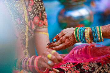Hands of bride is decorated beautifully by indian mehndi art along with jewelery’s and colorful bangles