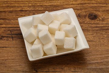 Refined white sugar cubs in the bowl