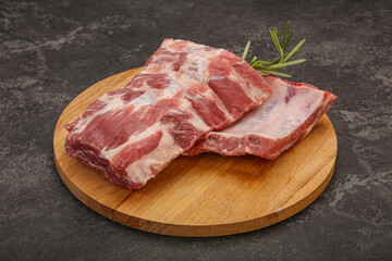 Raw pork ribs served rosemary