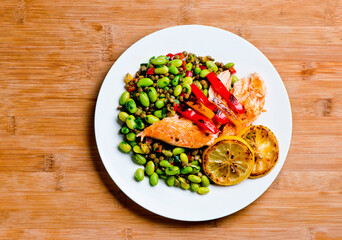 Salmon. Pan roasted Cajun seasoned salmon fillet. Served with rice pilaf, organic steamed vegetables, bell peppers, squash, carrots and zucchini. Classic American diner lunch favorite.