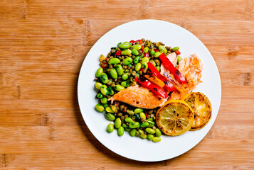 Salmon. Pan roasted Cajun seasoned salmon fillet. Served with rice pilaf, organic steamed vegetables, bell peppers, squash, carrots and zucchini. Classic American diner lunch favorite.