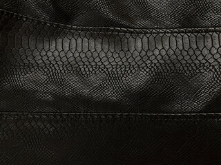 Black leather, clothes, jacket, large seams. Artificial leather looks like a snake skin, a crocodile