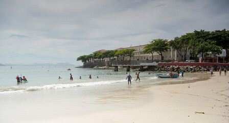 Citizens swimming in the ocean. Copacabana Fort