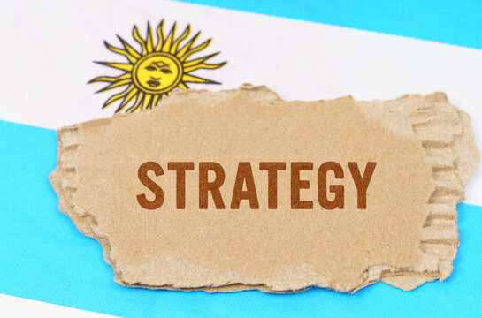 Against the background of the flag of Argentina lies cardboard with the inscription - Strategy