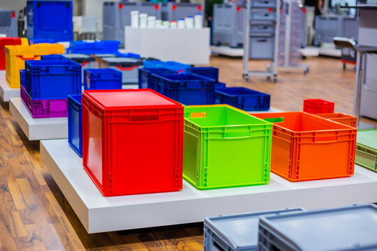 Many colorful plastic boxes, containers, crates at storage, warehouse, exhibition. Recycling, logistic and trade concept