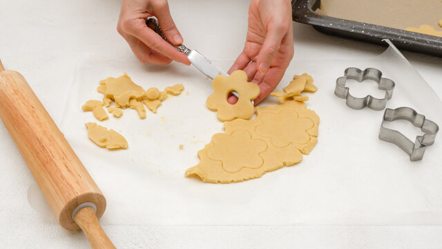 Shortbread cookies with raspberry jam recipe. Step by step baking process. Woman placing cookies on a prepared baking pan