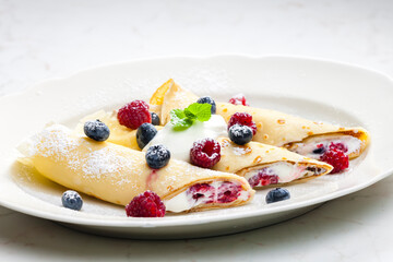 pankaces filled with blueberries, raspberries and cream