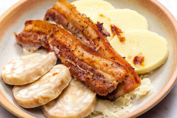 pork meat with two types of dumplings and cabbage