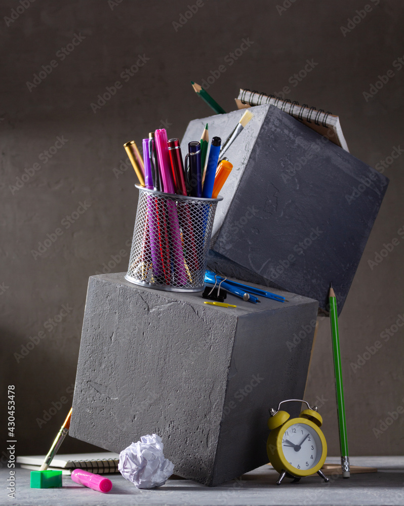 Poster Study supplies and accessories on concrete cube background. Back to school concept